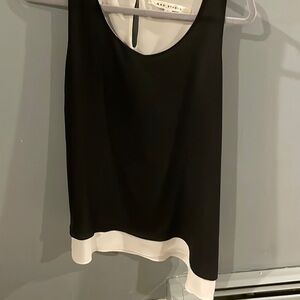 Asymmetrical, sleeveless, black and white blouse size large